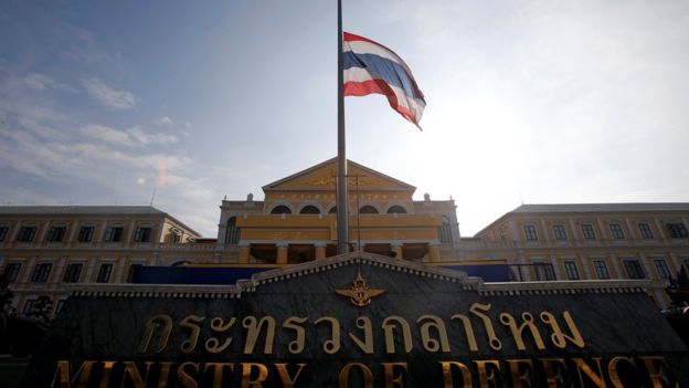 A Thai national flag flies at half mast