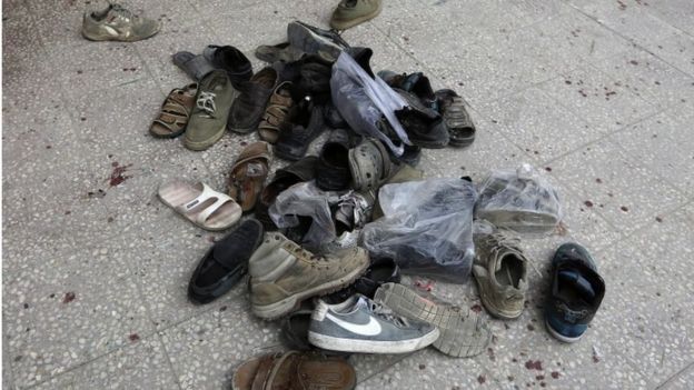 Shoes of worshippers outside a mosque in Kabul hit by a suicide bomber, 21 November 2016