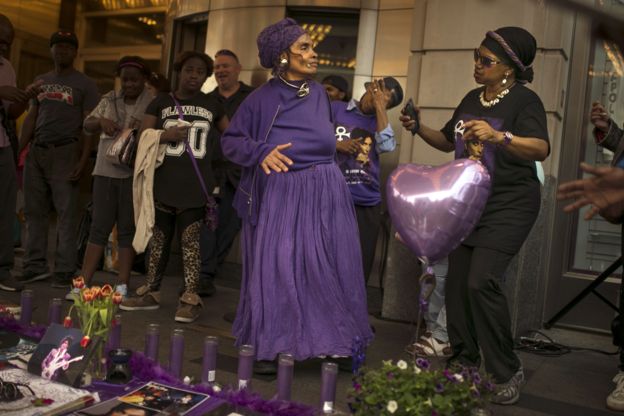 Fans gather and dance to Prince's songs outside the Apollo Theatre in New York, 22 April