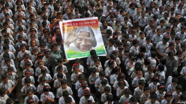 Teachers and schoolchildren hold a portrait of the former Indian President A. P. J. Abdul Kalam during a prayer ceremony in Agartala, India, July 29, 2015