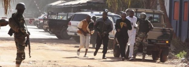 People run to flee from the Radisson Blu Hotel in Bamako, Mali, Friday 20 November 2015