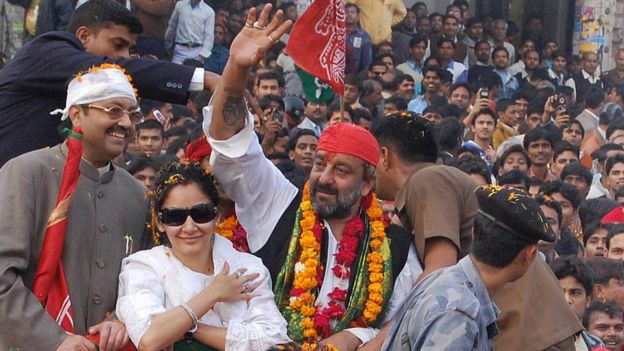 Sanjay Dutt (centre), accompanied by his wife Manyata, waves to the crowd during an election road show in Lucknow on January 17, 2009.