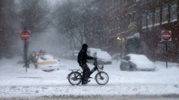 A biker is seen riding through the snow on the Lower East Side of Manhattan during a large winter storm in New York, New York, USA, 23 January 2016
