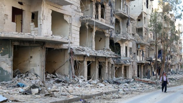 A man walks past damaged buildings in the rebel held besieged al-Sukkari neighbourhood of Aleppo, Syria October 19, 2016