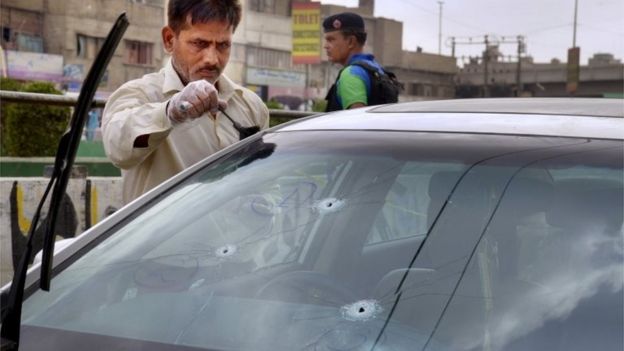 A forensic expert collects evidence from the car of famous Sufi singer Amjad Sabri after an attack in Karachi, Pakistan, Wednesday, June 22, 2016.