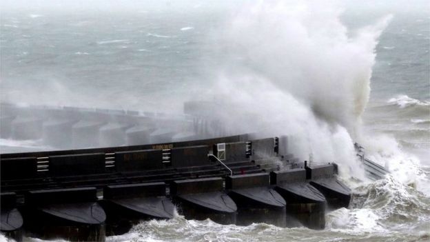 Waves crash over marina wall in Brighton
