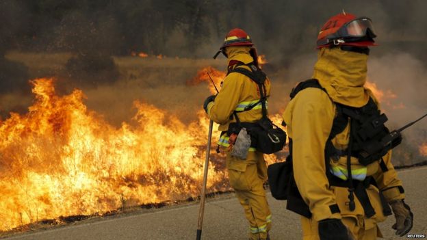 Firefighters watch a controlled burn along Morgan Valley Road during the so-called Jerusalem Fire in Lake County, California August 12, 2015