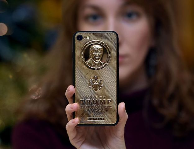 A gold-plated smartphone bearing Trump's likeness is sold at a boutique in Moscow