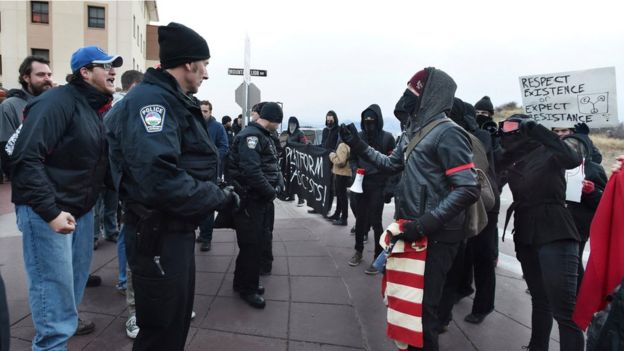 Colorado Springs police make a barrier between protesters against Milo Yiannopoulos, who are on the right, and those going to hear him speak at University of Colorado in January 2017