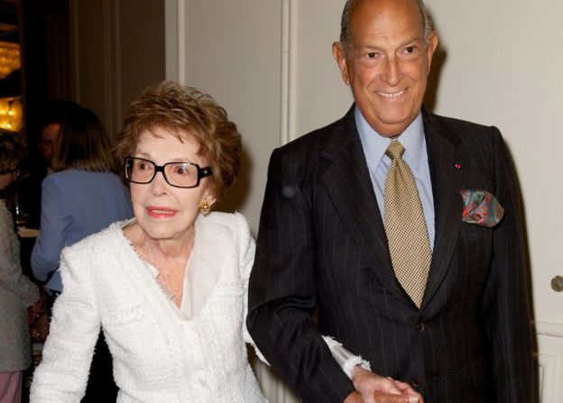 Former first lady Nancy Reagan, left, is escorted by fashion designer Oscar de la Renta