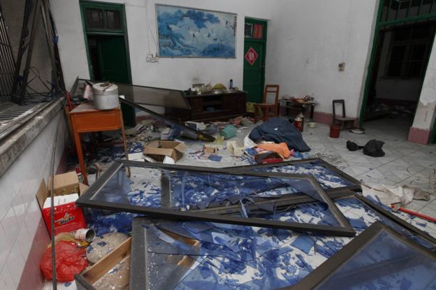 Damaged windows are seen on the ground of a room at the site of blasts in Liucheng county in Liuzhou in south China