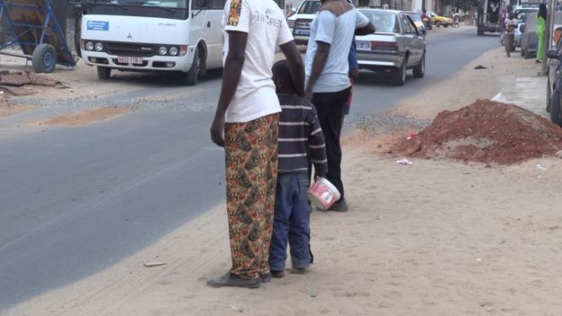 Man with child on street