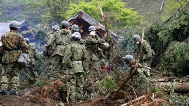 Japan Ground Self-Defense Force soldiers conduct search and rescue operations for a missing guest at a destroyed mountain villa following a landslide site caused by an earthquake in Minamiaso town, Kumamoto prefecture, southern Japan, in this photo taken by Kyodo April 18, 2016.