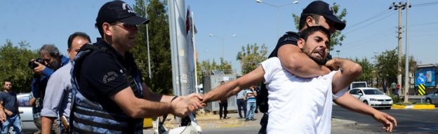 Turkish police detain a teacher during a protest in Diyarbakir on September 9, 2016