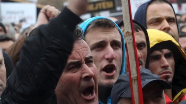 A man waves his fist during the protest