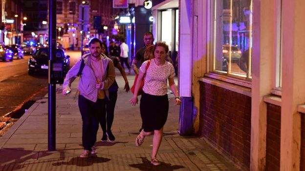 People run down Borough High Street as police are dealing with a 