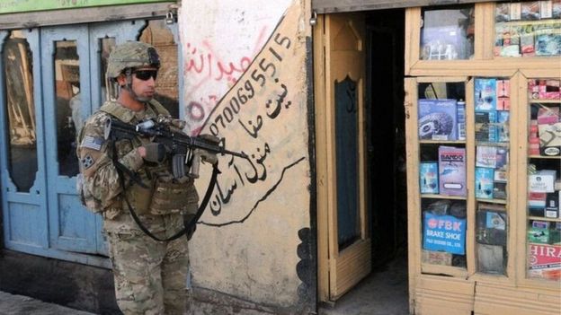 A US soldier patrols the streets of Asadabad, Afghanistan