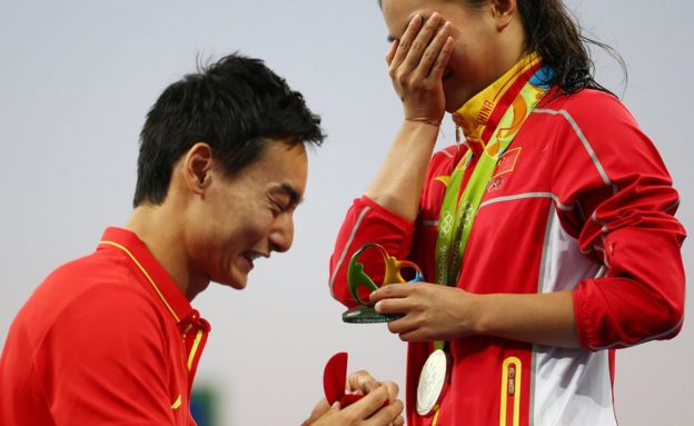 He Zi (CHN) of China recieves a marriage proposal from Olympic diver Qin Kai (CHN) of China after the medal ceremony.