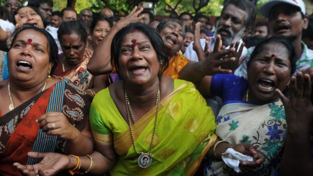 Indian supporters of the Chief Minister of Tamil Nadu Jayalalitha react outside the hospital after false reports that she had died in Chennai