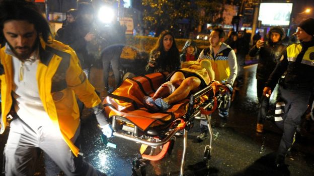 An injured woman is taken to an ambulance in Istanbul