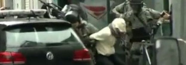 The moment Salah Abdeslam is bundled into a police car following his capture