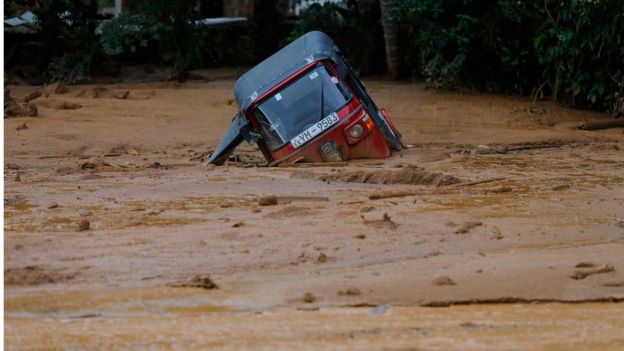 An auto-rickshaw, half submerged in floodwaters in Elangipitiya village on 18 May 2016