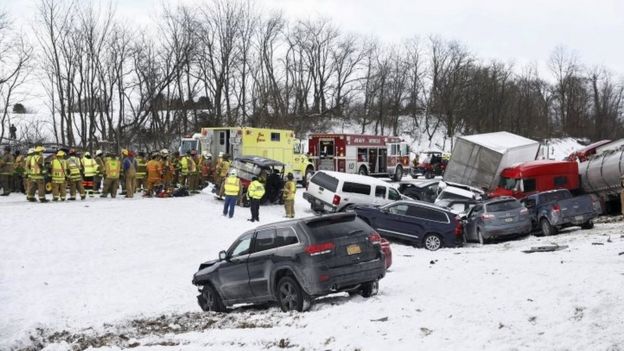Emergency personnel work at the scene of a crash (13 February 2016)