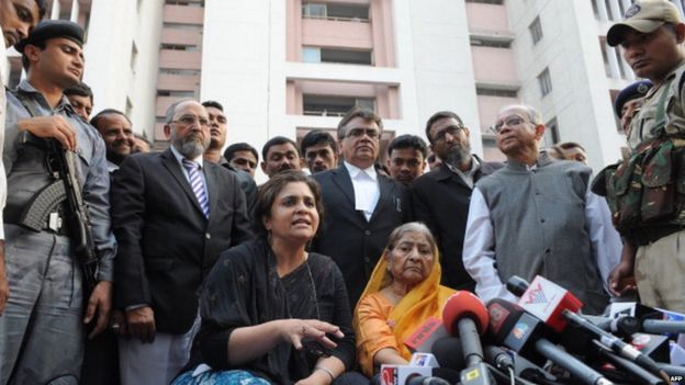 Indian widow Zakia Jafri (C/R in saree) listens as activist, Teesta Setalvad (C/L) addresses media representatives outside a court in Ahmedabad on December 26, 2013, following a judgement in favour of Chief Minister of Gujarat Narendra Modi over his role in 2002 religious riots