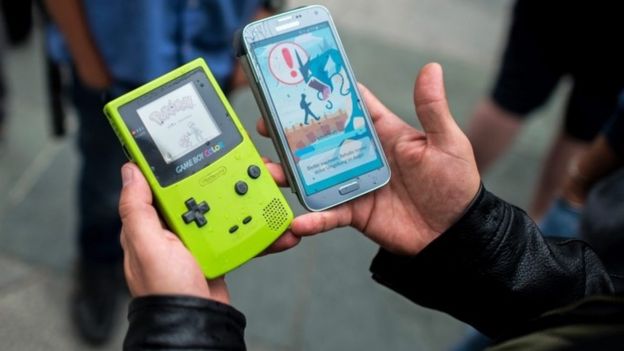 A gamer displays the Pokemon video game on a Game Boy (left) and the Pokemon Go app on a smartphone (right) - (16 July 2016)