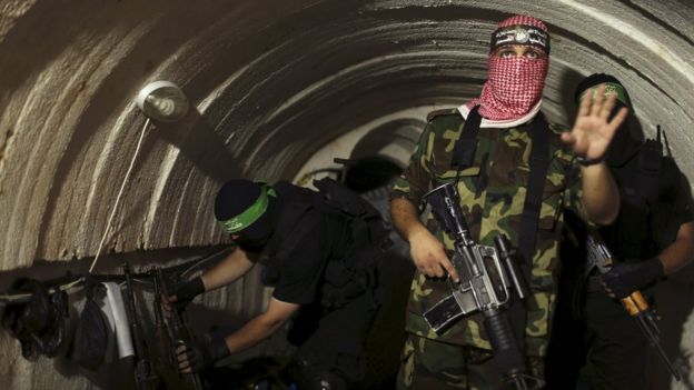 A Palestinian militant f-rom the Izz al-Din al-Qassam Brigades, the armed wing of the Hamas movement, gestures inside an underground tunnel in Gaza (18 August 2014)