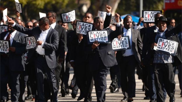 This file photo taken on 19 January 2015 shows men holding signs reading 