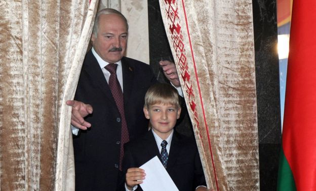 Belarus's President Alexander Lukashenko (left) stands with his son Kolya prior to cast his ballot on September 23, 2012 in Minsk
