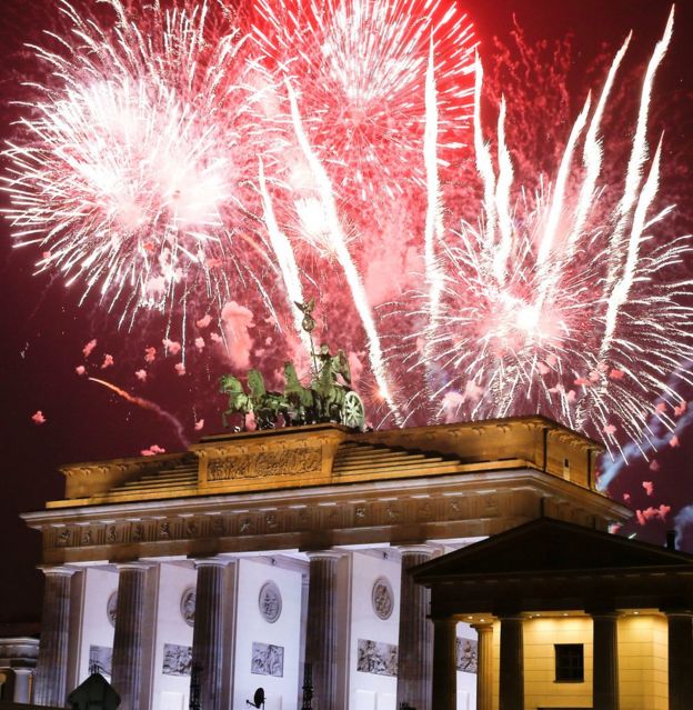 Fireworks explode next to the Quadriga sculpture atop the Brandenburg gate during New Year celebrations in Berlin