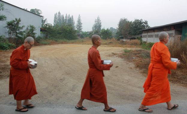 Monks go out to collect alms