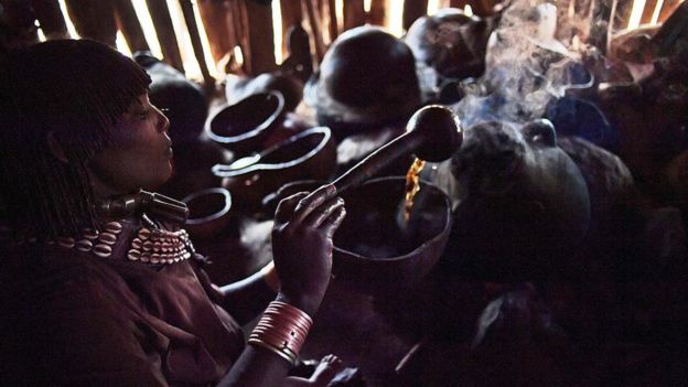 A woman from the Hamar tribe makes traditional coffee in Ethiopia's southern Omo Valley region near Turmi on September 20, 2016.