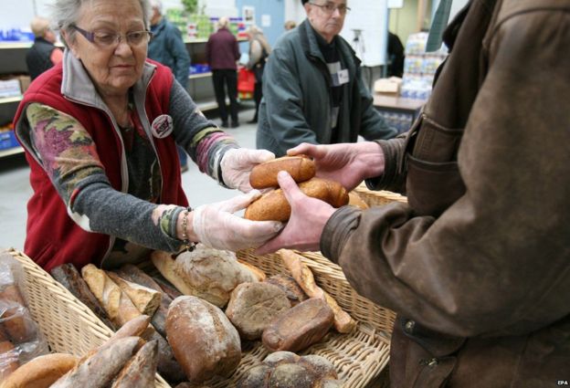 A volunteer delivers bread at the distribution centre of the Restos du Coeur