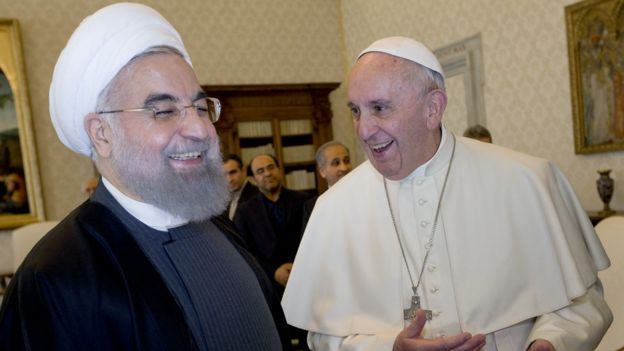 Iranian President Hassan Rouhani laughs with Pope Francis