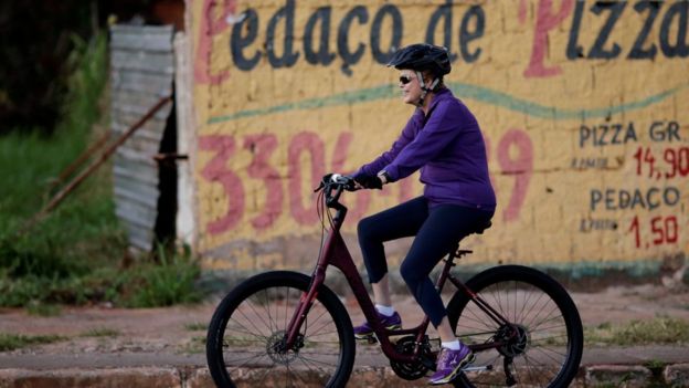 President Dilma Rousseff rides her bicycle near the Alvorada Palace in Brasilia, 15 April 2016.