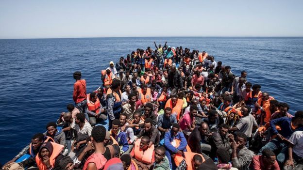 Migrants crowd the deck of their wooden boat off the coast of Libya on 14 May 2015.