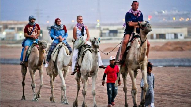 Tourists ride camels in Egypt's Red Sea resort of Sharm el-Sheik