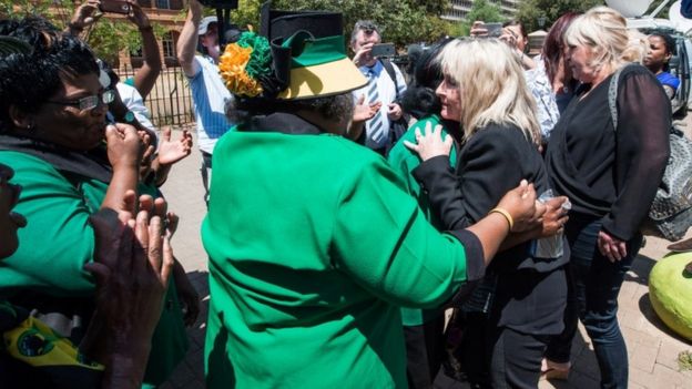June Steenkamp (2nd from R), the mother of Reeve Steenkamp, is embraced by African National Congress Women League