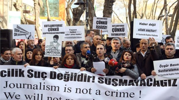 Turkish journalists hold a banner reading 