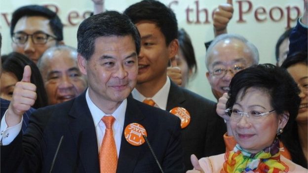 Hong Kong chief executive elect Leung Chun-ying (L) and his wife Regina Leung (R) gives a thumbs up sign at a press conference after Leung Chun-ying won the Hong Kong chief executive election on March 25, 2012