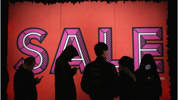 Shoppers queue outside Selfridges for the sale