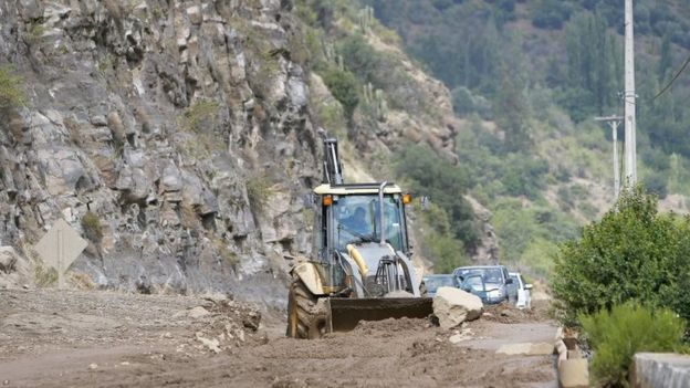 A tractor clears the road heading toward San Jose de Maipo Volcano after heavy rains caused landslides in the San Jose de Maipo region, near Santiago, Chile, 26 February 2017.