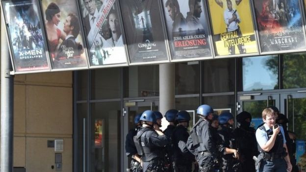 Police forces stand in front of a cinema where an armed man barricaded himself in Viernheim, southern Germany, on June 23, 2016