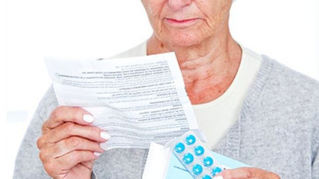 Woman reading patient information leaflet