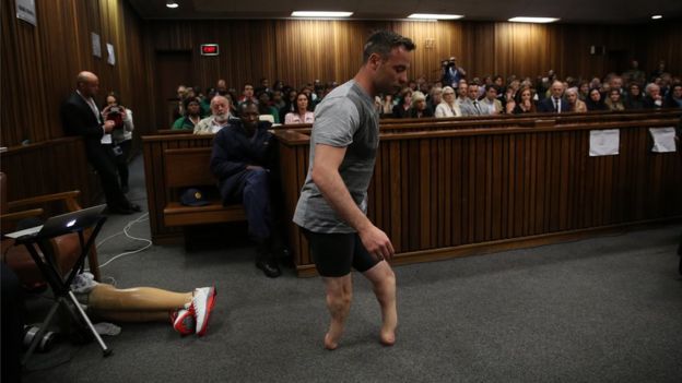 Oscar Pistorius walks across the courtroom without his prosthetic legs during the third day of Oscar's hearing for a resentence at Pretoria High Court on June 15, 2016 in Pretoria, South Africa.