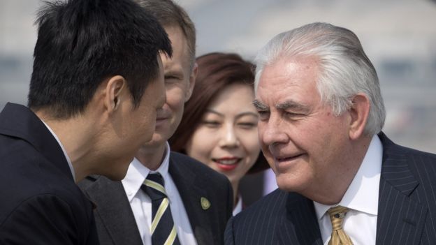 US Secretary of State Rex Tillerson (R) is greeted as he arrives at Beijing Capital International Airport on March 18, 2017.