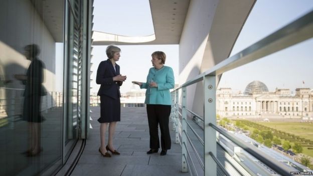 Theresa May and Angela Merkel talking at the German Chancellery